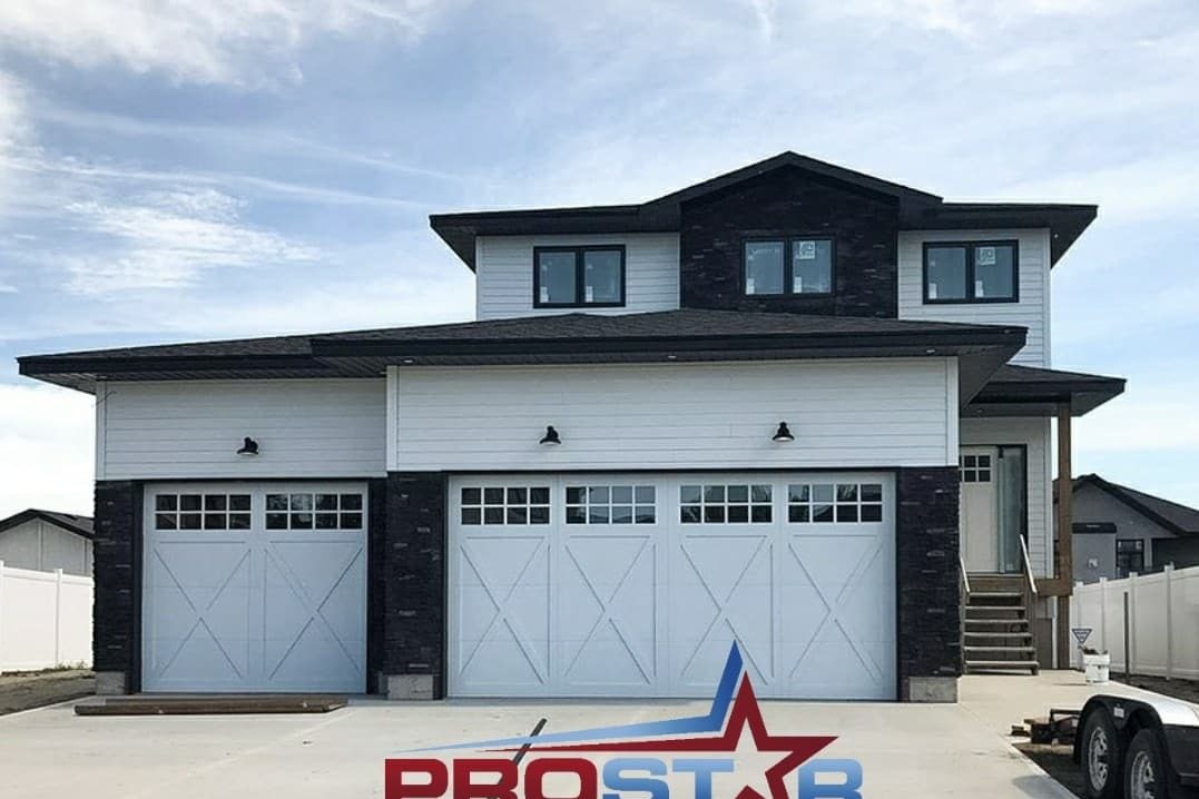 Two new white carriage-style garage doors on a newly built North Texas home