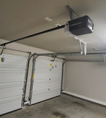 New garage door opener installed on the ceiling of a two-car garage